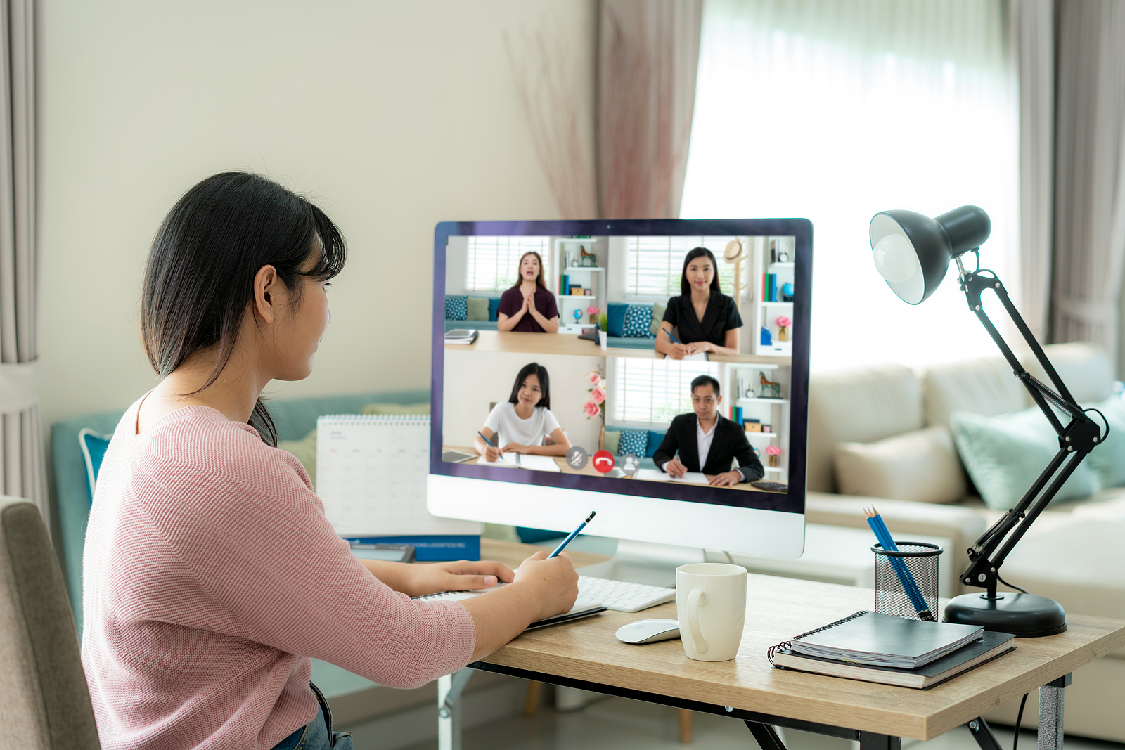 Multiethnic tech professional team using a video for an online networking session.